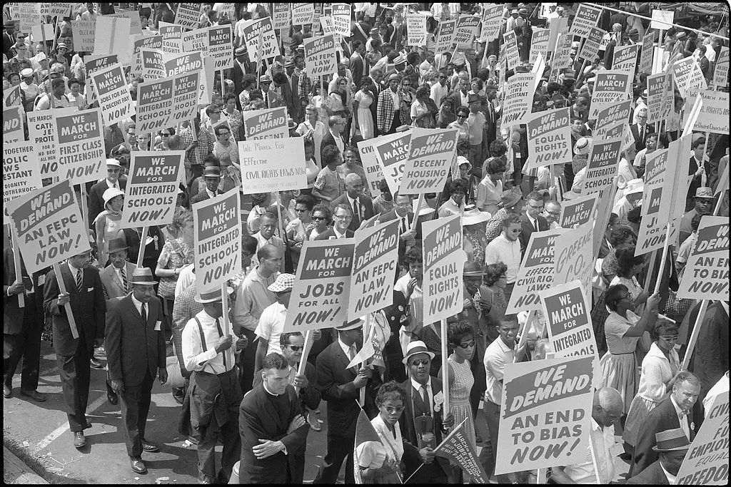 [Demonstrators marching in the street holding signs during the March on Washington, 1963] / MST.